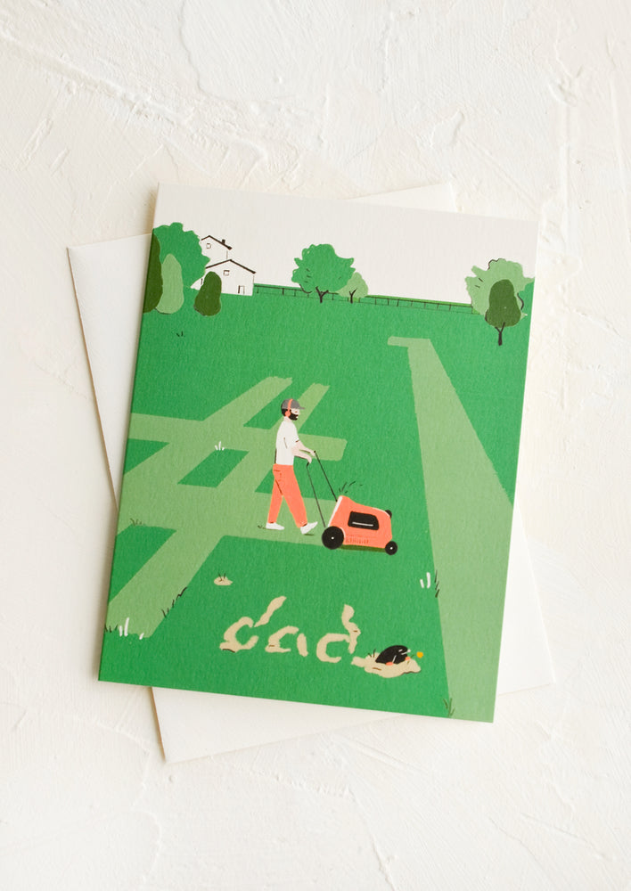 1: A greeting card picturing a man mowing the grass. 