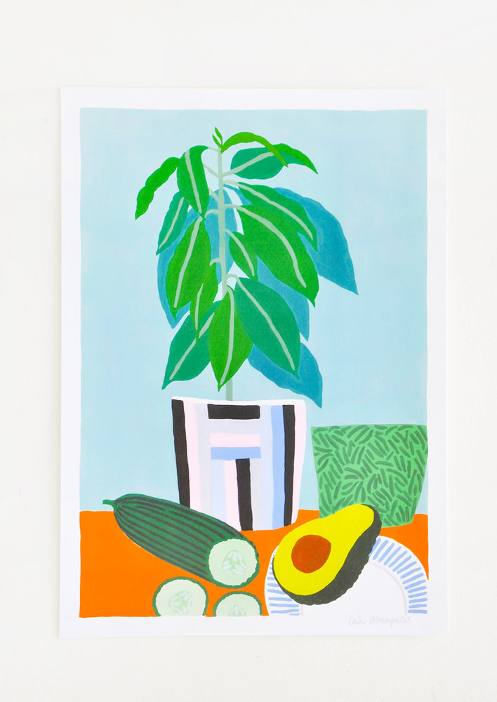 Still life of a cut cucumber, half an avocado, and a houseplant on an orange table against a pale blue background.