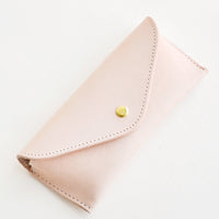 Natural: Pale pink leather case for sunglasses that folds close with a snap.