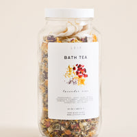 1: A potpourri filled glass jar with a white plastic lid and white label featuring black text and an image of dried flower petals.