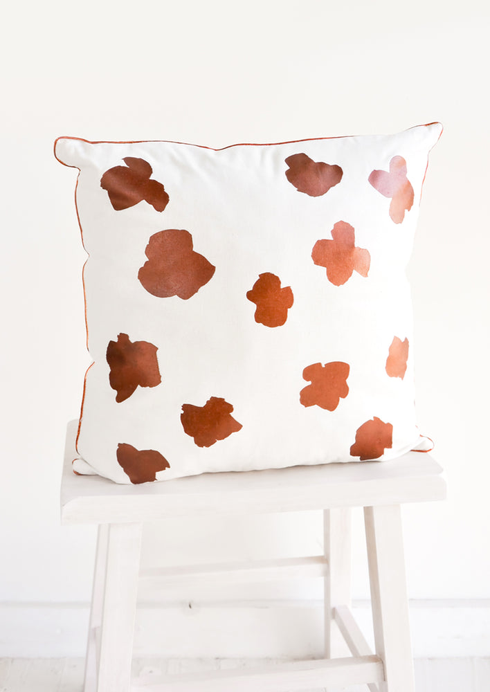 1: Square Throw Pillow in White with Copper Abstract Flower Print on Front
