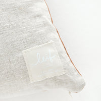 3: Logo patch on linen pillow back