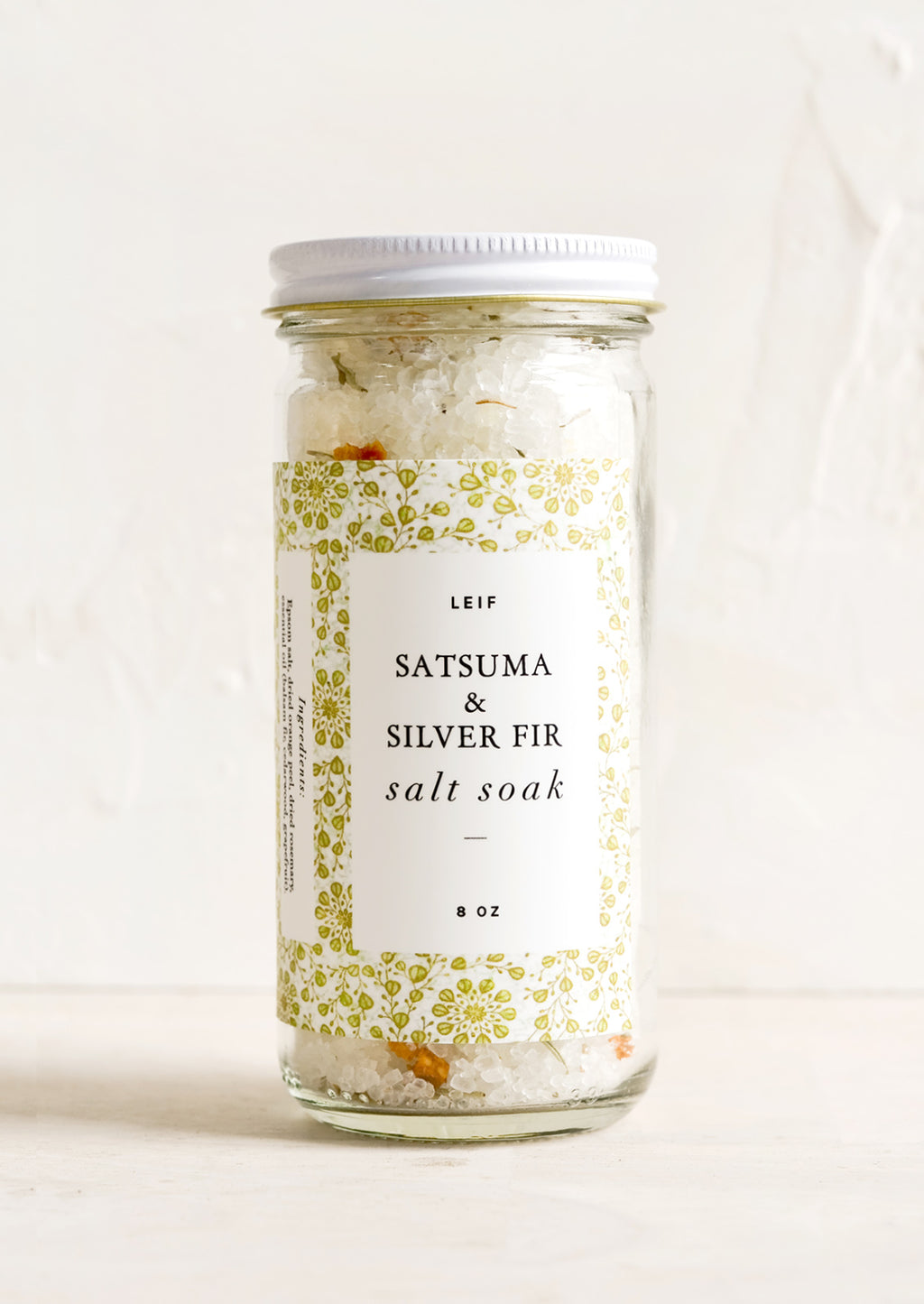 Satsuma & Silver Fir: A straight sided glass jar containing Satsuma & Silver Fir salt soak.