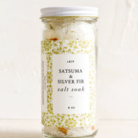 Satsuma & Silver Fir: A straight sided glass jar containing Satsuma & Silver Fir salt soak.