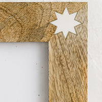 2: White resin star detailing on wood.