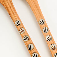 3: Detail of round, patterned bone inlay on spoon handles