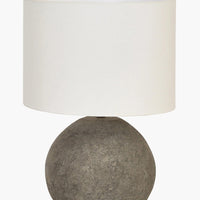 2: A table lamp with round black terracotta base and white cylinder shade.