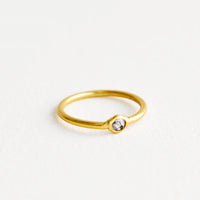 1: Yellow brass ring with a slim band and a small diamond stone.