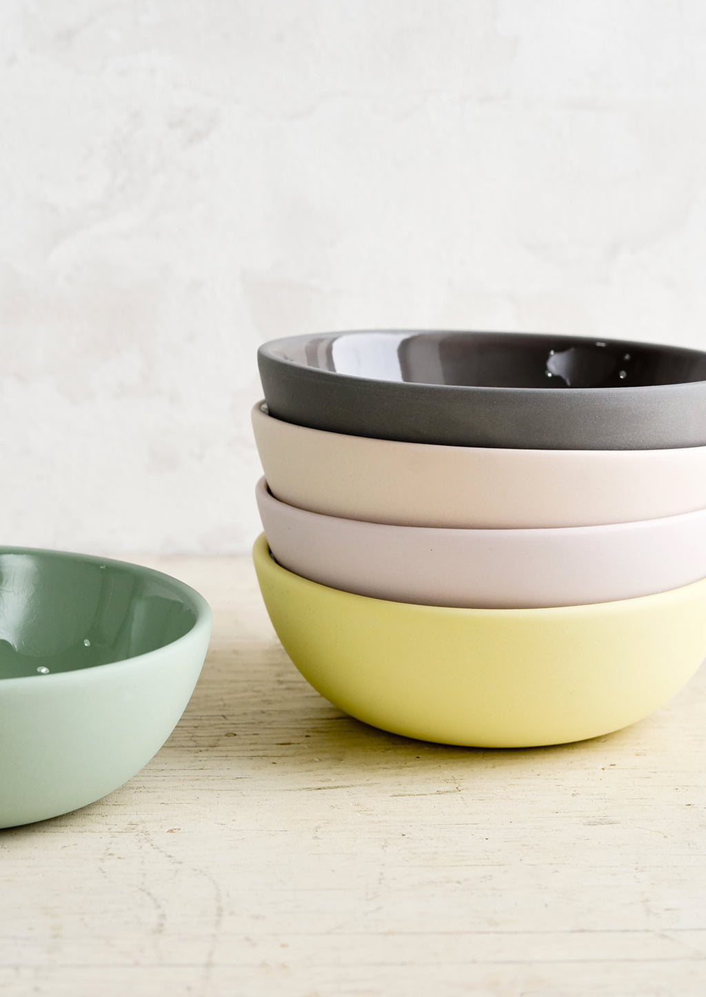 3: A stack of bowls with matte exterior and glossy interior in assorted pastel hues.