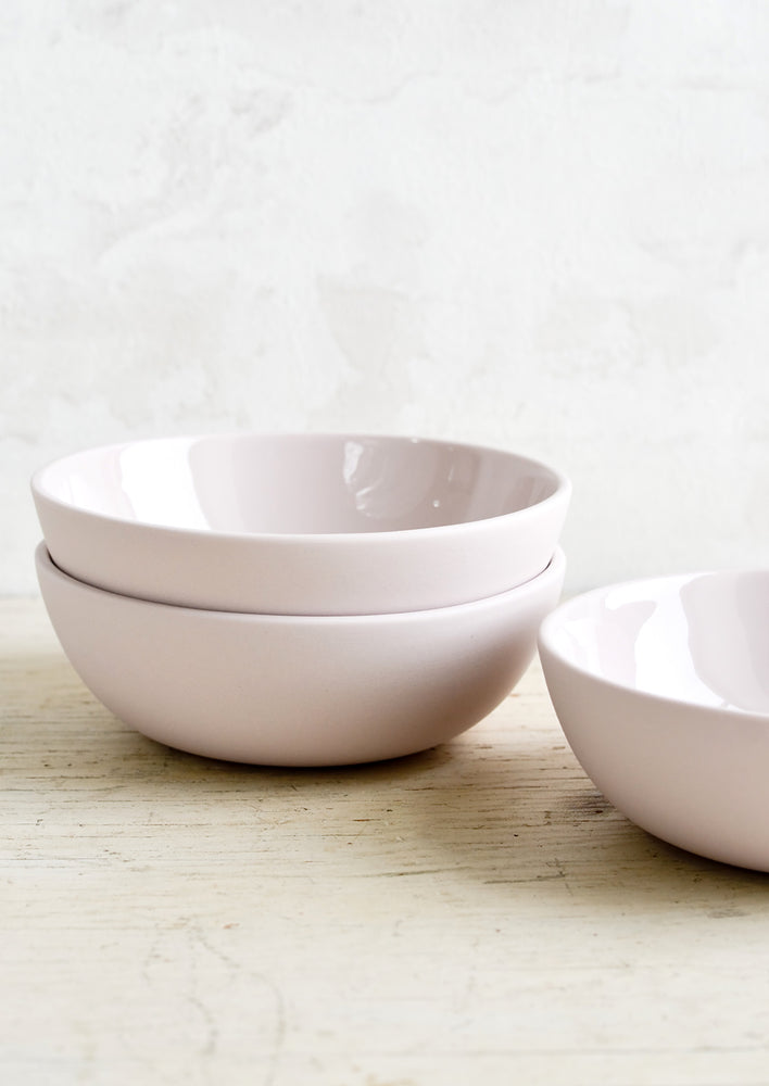 Matte porcelain bowls in pale lavender with glossy interior.