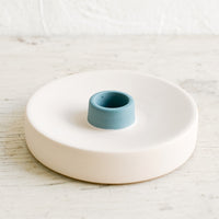 Single / Bisque / Teal: A round ceramic taper candle holder in nude and blue.