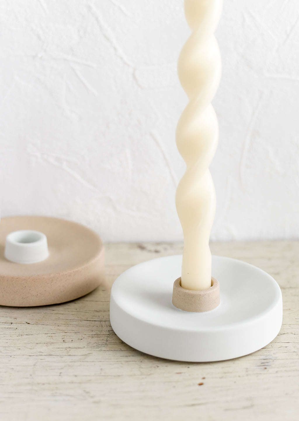 5: Neutral colored ceramic taper holders with ivory candle.