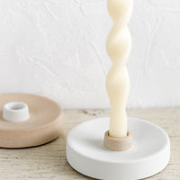 5: Neutral colored ceramic taper holders with ivory candle.