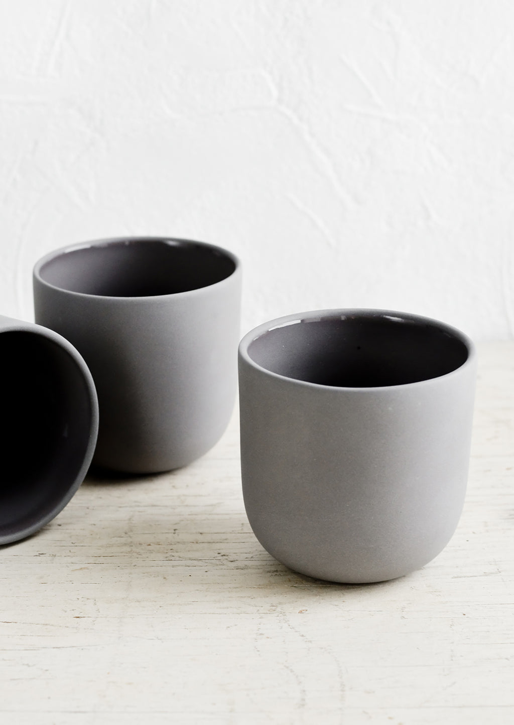 Charcoal: Three dark grey matte porcelain short tumblers.