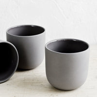 Charcoal: Three dark grey matte porcelain short tumblers.