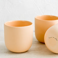 Cantaloupe: Three orange matte porcelain short tumblers.