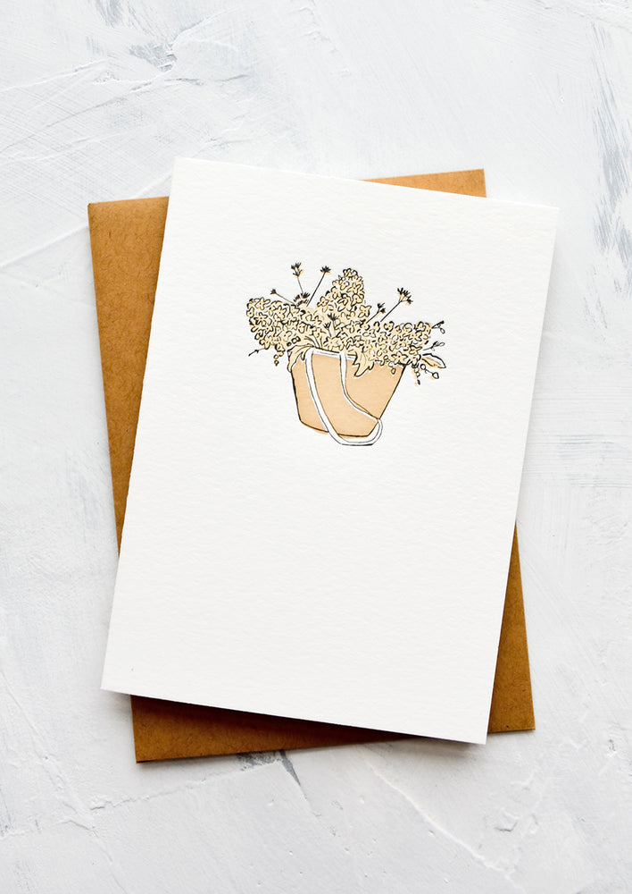 1: A letterpress printed greeting card with an image of hydrangeas in a tote bag