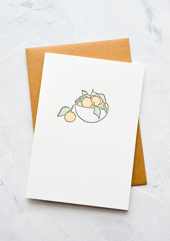A letterpress printed greeting card with an image of satsumas in a bowl