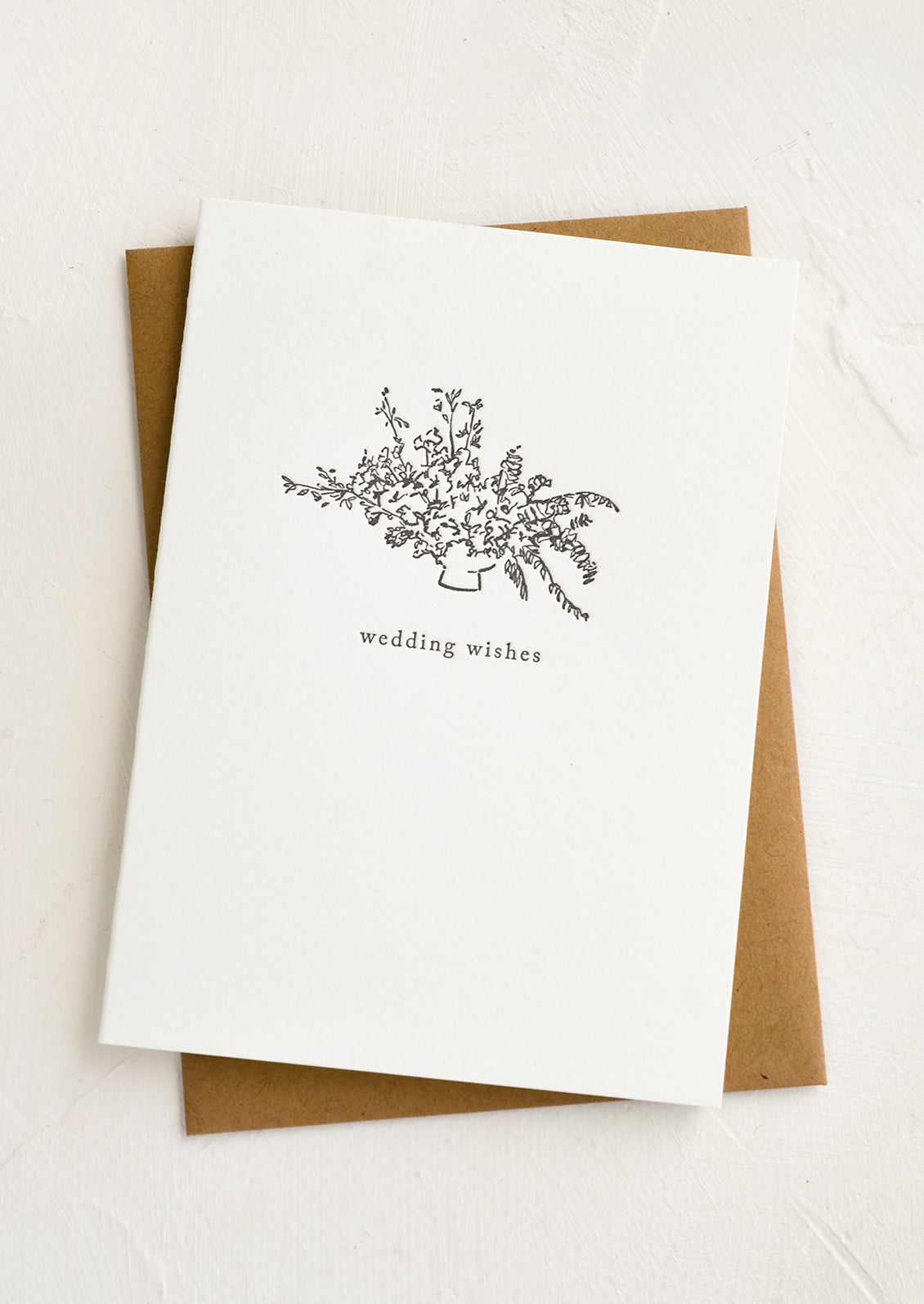 Lettered press printed card with bouquet and small text reading "Wedding wishes".