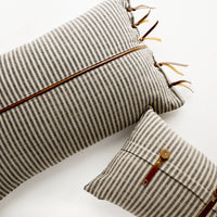 3: Lumbar throw pillows in tan and black striped fabric with brown leather details
