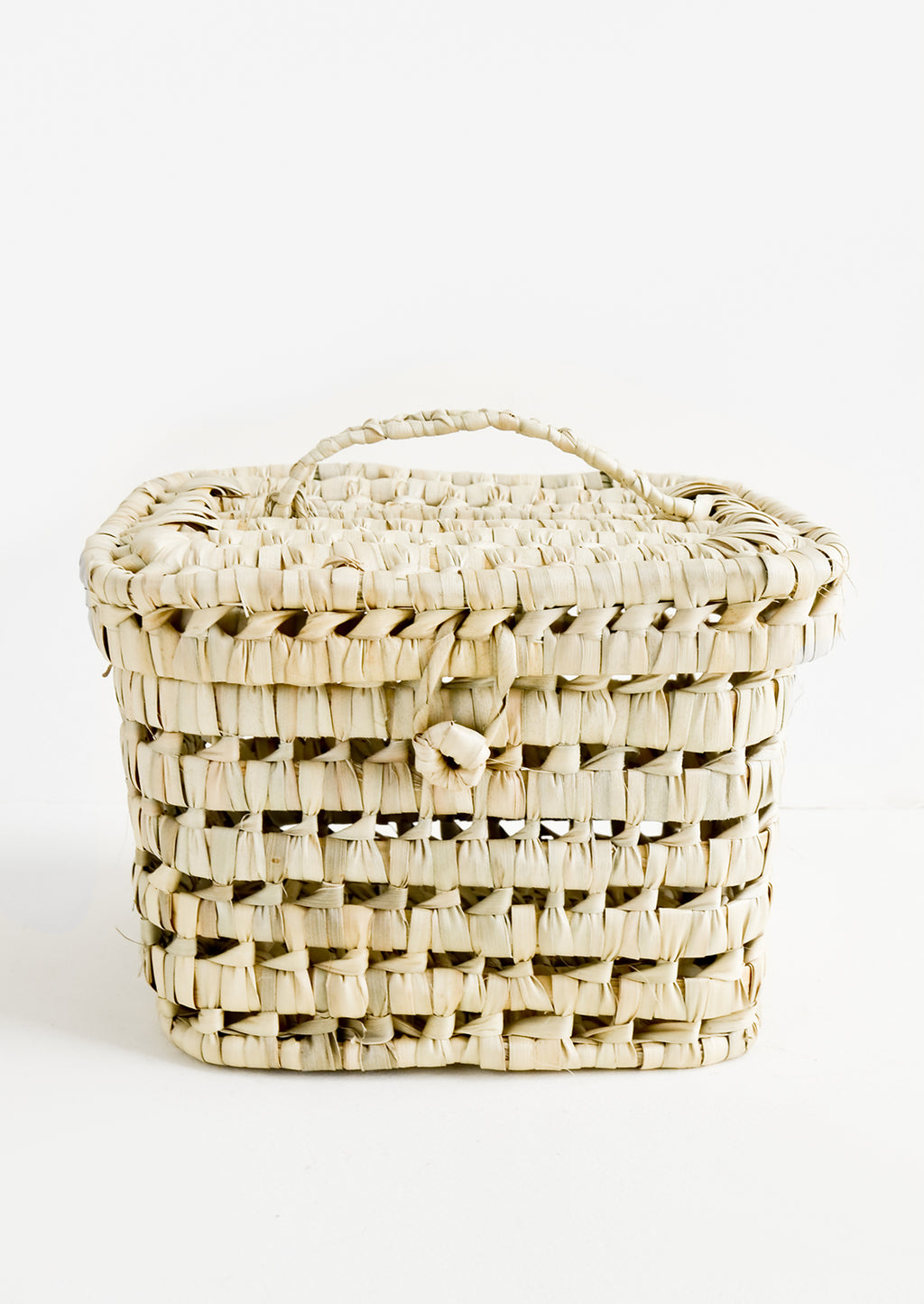 1: A square-shaped, lidded basket made from woven natural palm leaf.