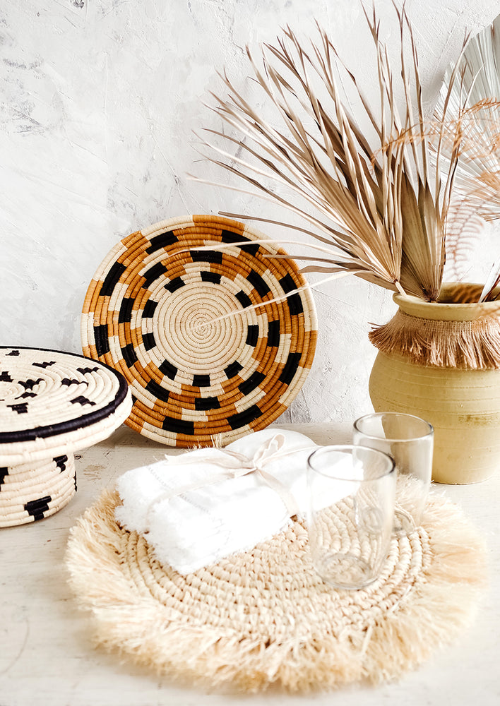 Variety of tabletop decor in neutral hues arranged on a tabletop
