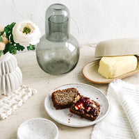 3: An arrangement of tableware artfully arranged atop a rustic white table.