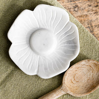 1: A white marble spoon rest in flower shape.