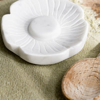 2: A white marble spoon rest in flower shape.