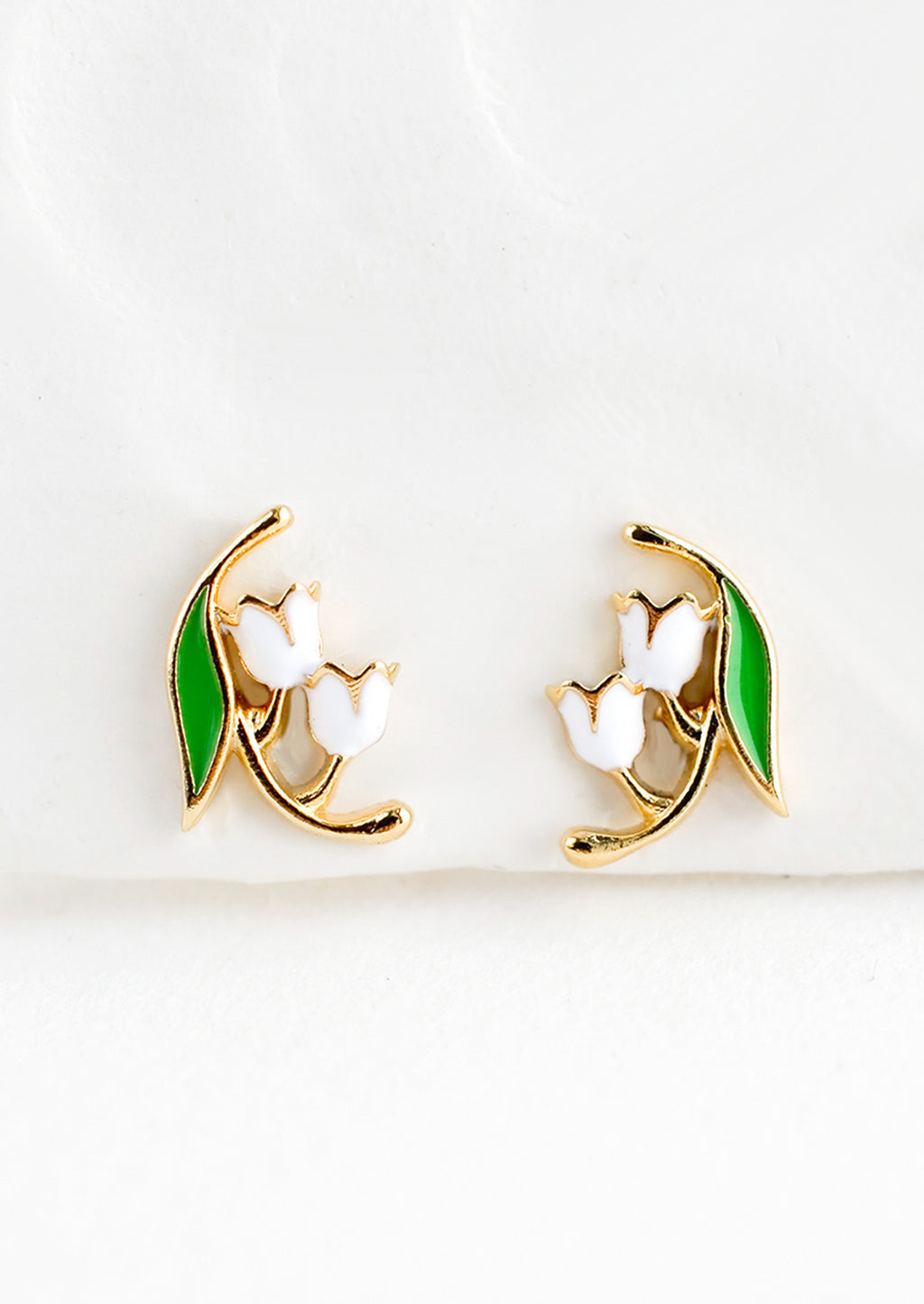 1: Small gold stud earrings in the shape of a lily of the valley flower, constructed in green and white enamel finish.