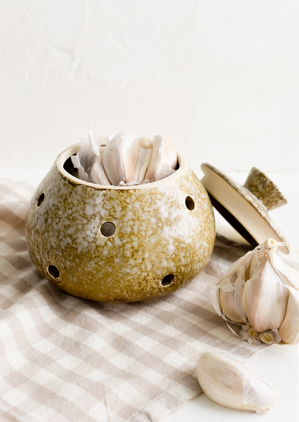 1: A brown ceramic garlic keeper with garlic heads.