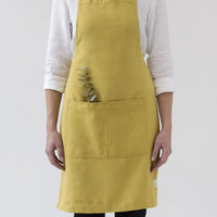 Chartreuse: A women wearing a linen apron in chartreuse color.
