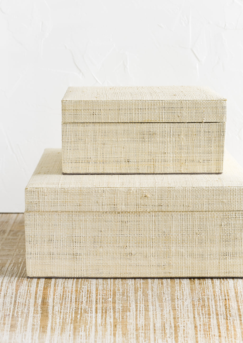 2: Small and large upholstered linen storage boxes.