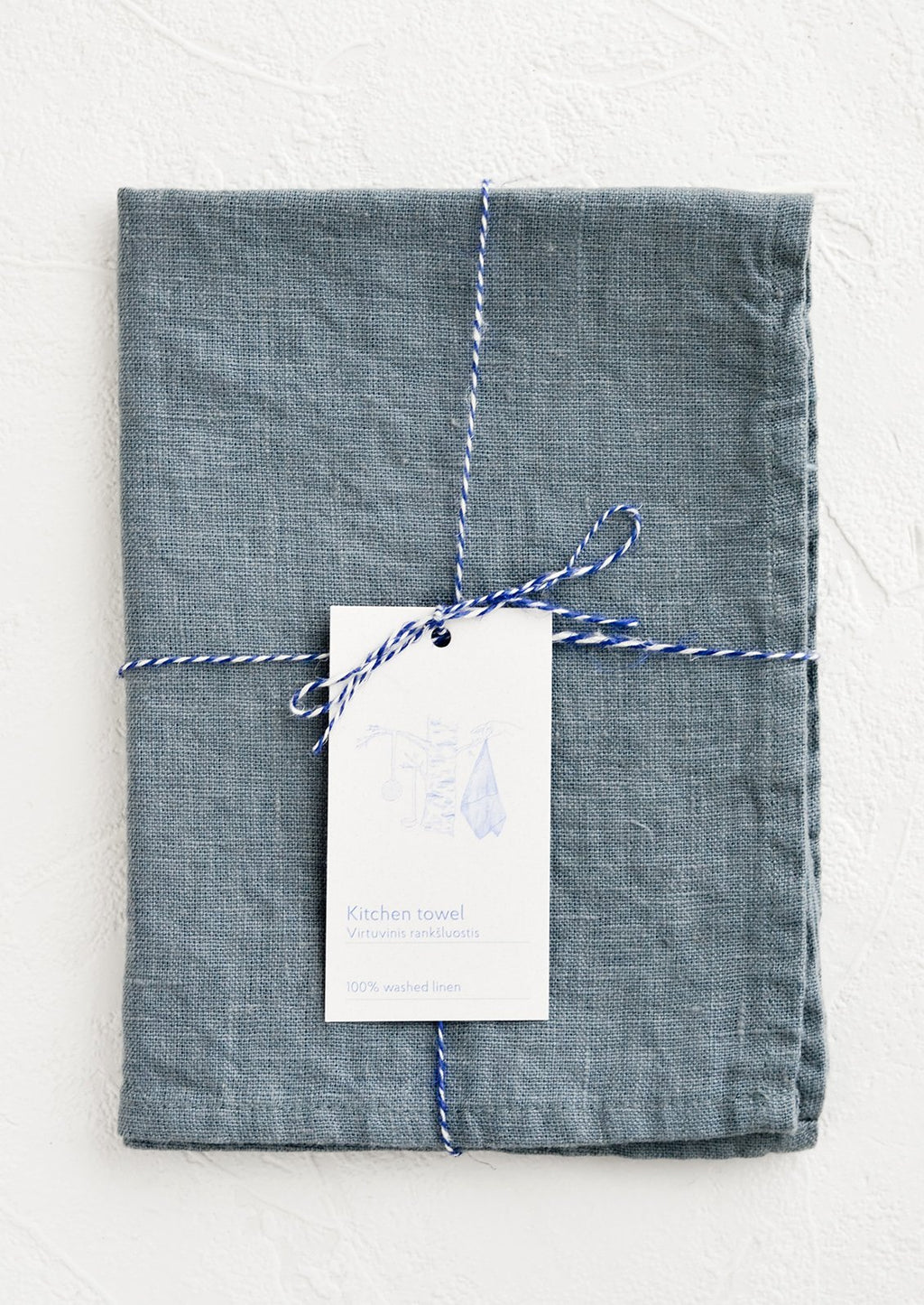 Blue Fog: A folded faded blue linen tea towel tied in baker's twine with a decorative hangtag