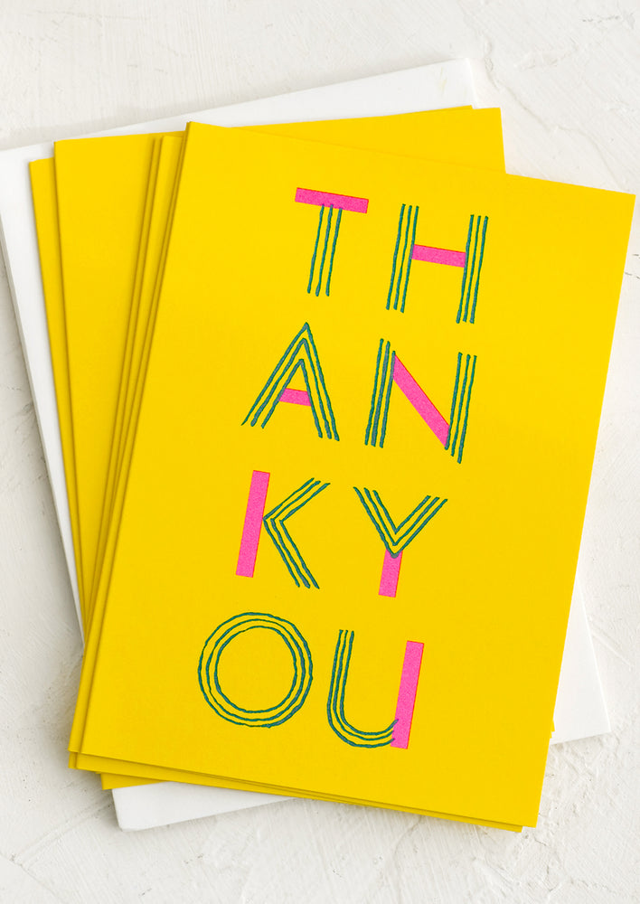 Yellow cards with line type font reading "Thank you".