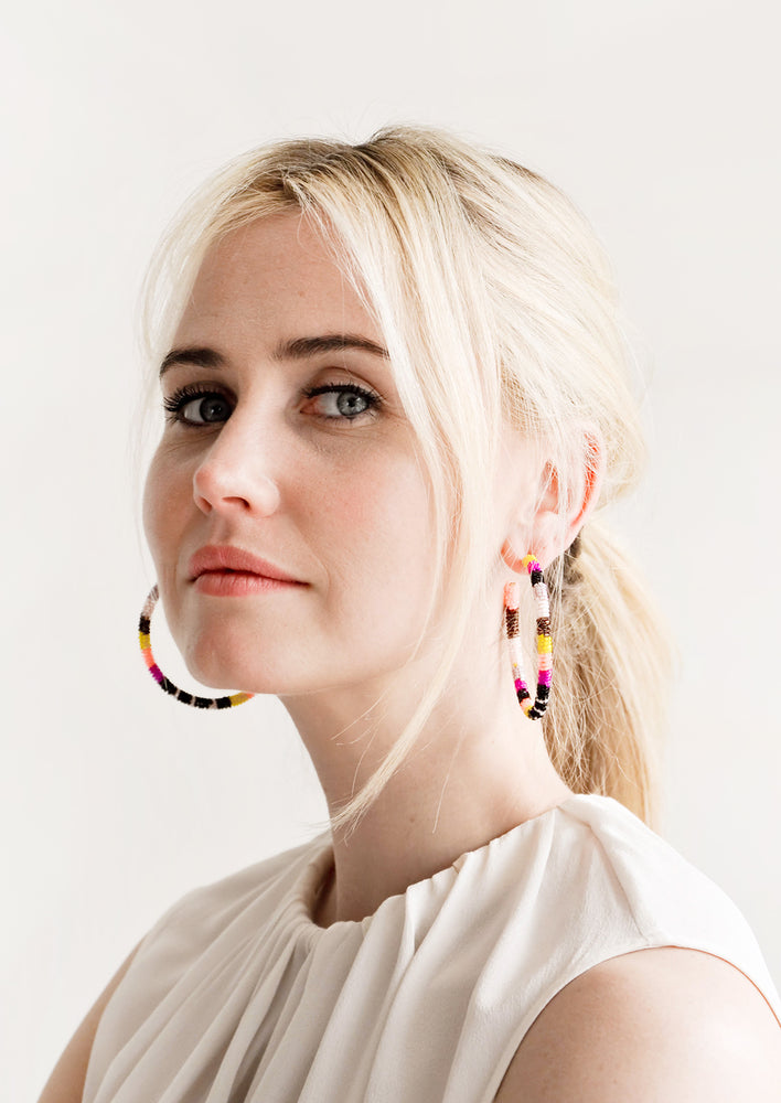 2: Model shot showing woman wearing hoop earrings and white top.