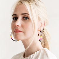 2: Model shot showing woman wearing hoop earrings and white top.
