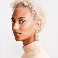 2: Model wears striped beaded fringe earrings.