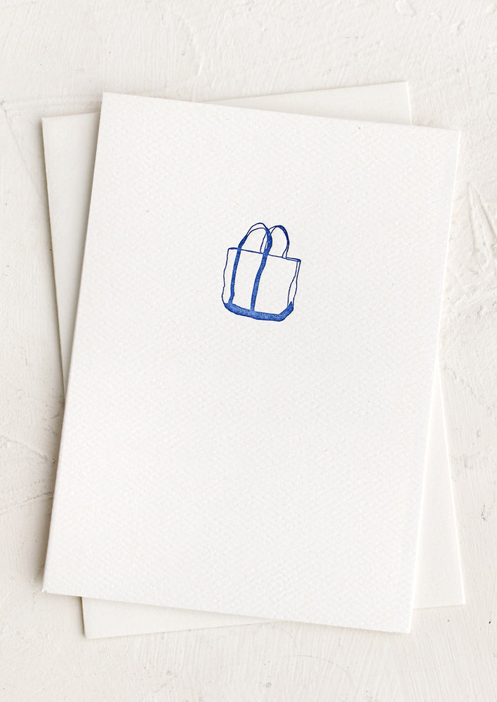 A plain white card with small boat bag icon at front.