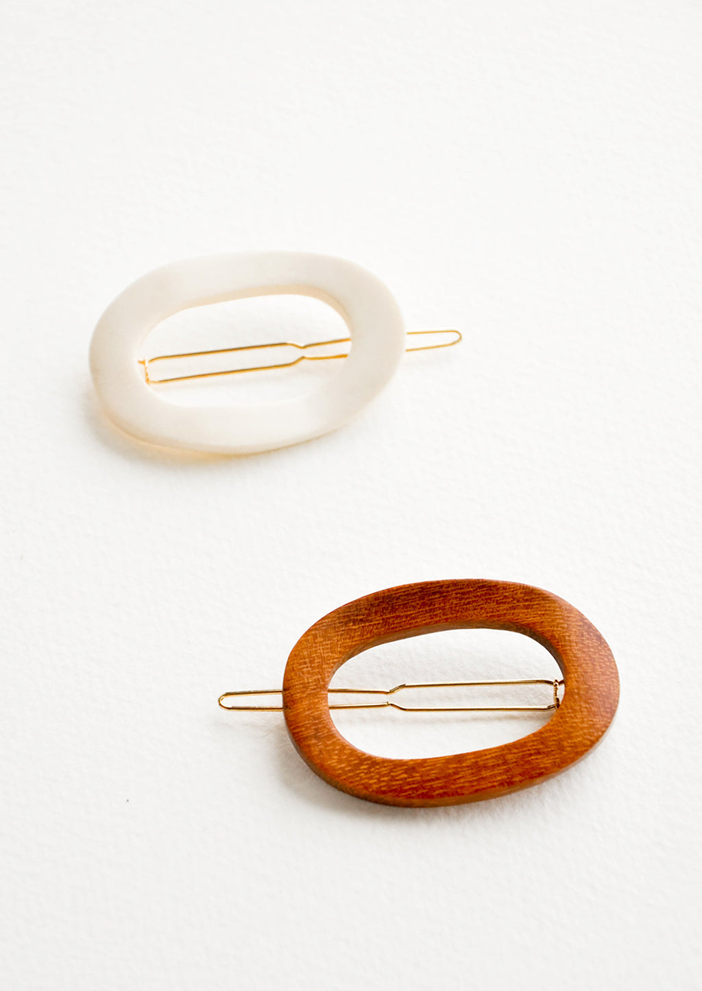 4: One brown and one white oval shaped hair clip