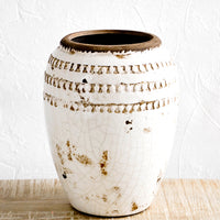 1: Distressed urn-shaped ceramic vase with glossy, crackled cream glaze and brown textured detailing