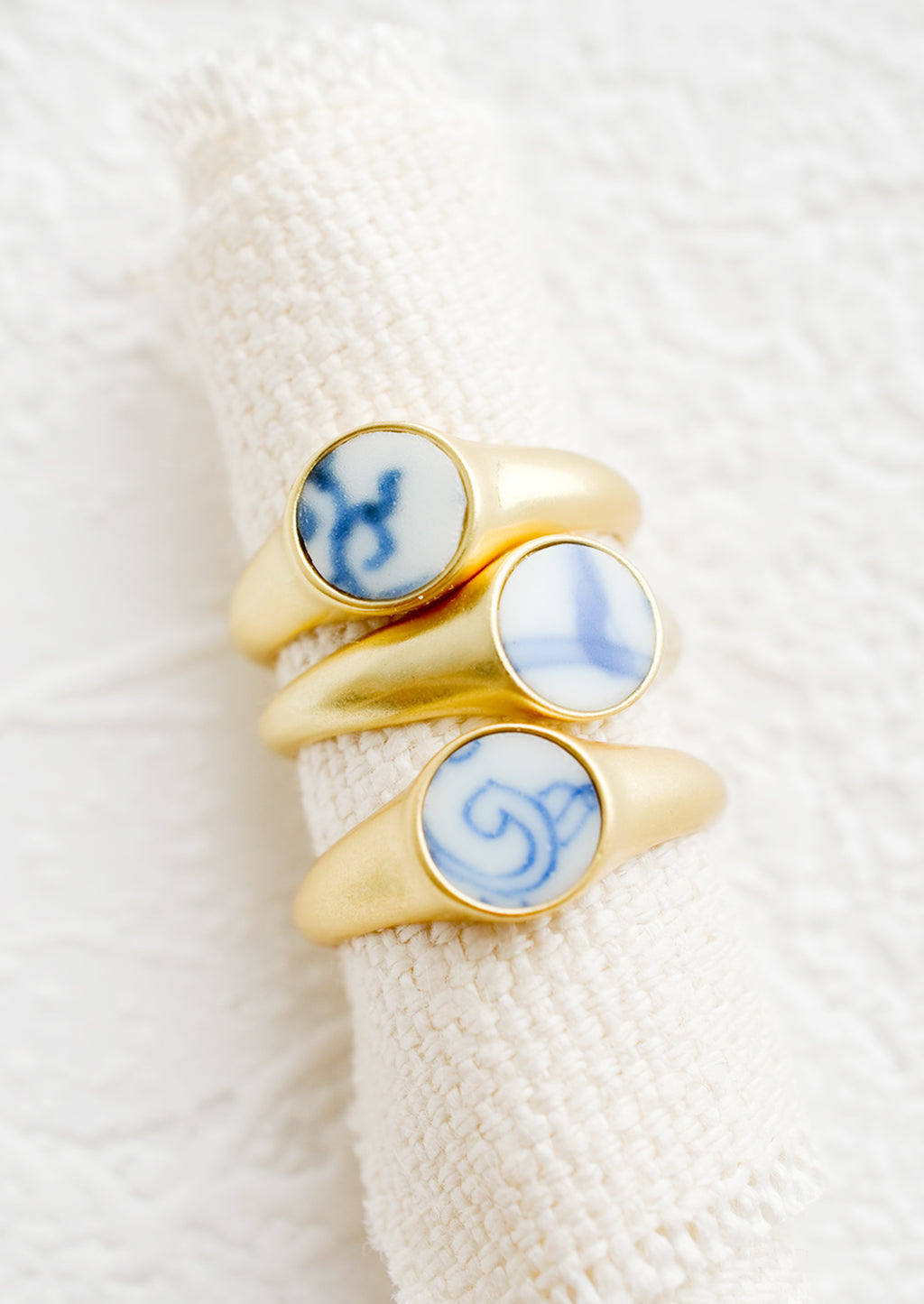 3: Gold signet rings with blue and white pottery signet.
