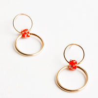 Orange Multi: Post back earrings of one small gold hoop and one larger gold hoop connected by a loop of orange glass beads.