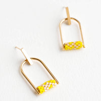 2: Arced gold post back earrings with yellow beads closing off the arc.
