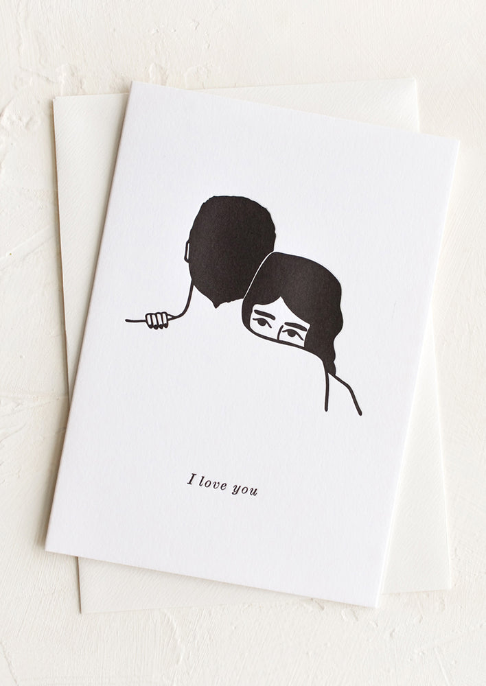 A greeting card picturing a woman embracing a man, text below image reads "I love you".