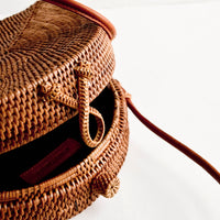 2: Woven clasp closure on smoked rattan handbag.