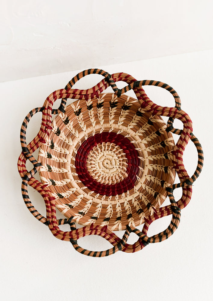 1: A woven basket with swirling, intertwined silhouette.
