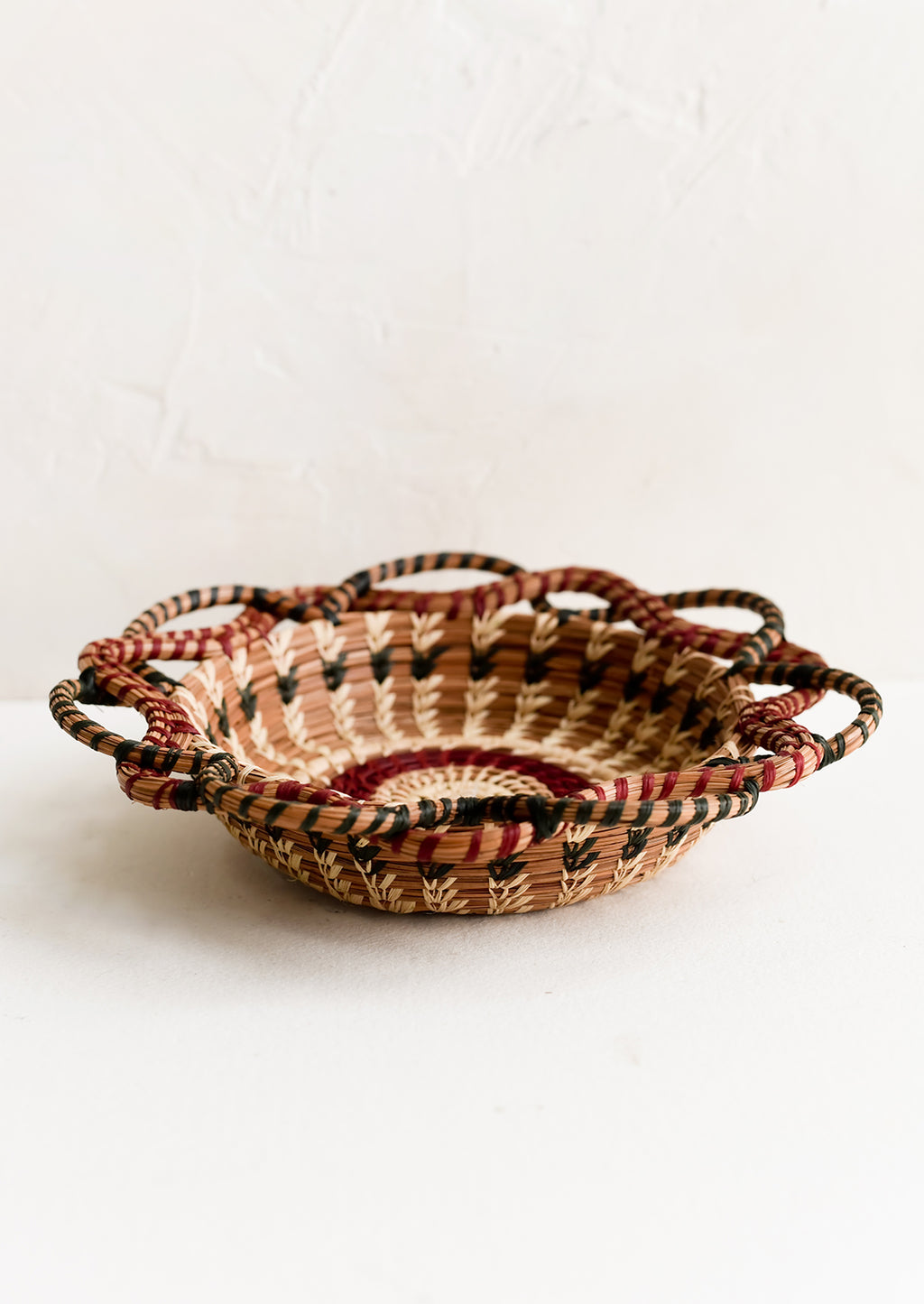 2: A woven basket with swirling, intertwined silhouette.