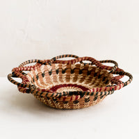 2: A woven basket with swirling, intertwined silhouette.