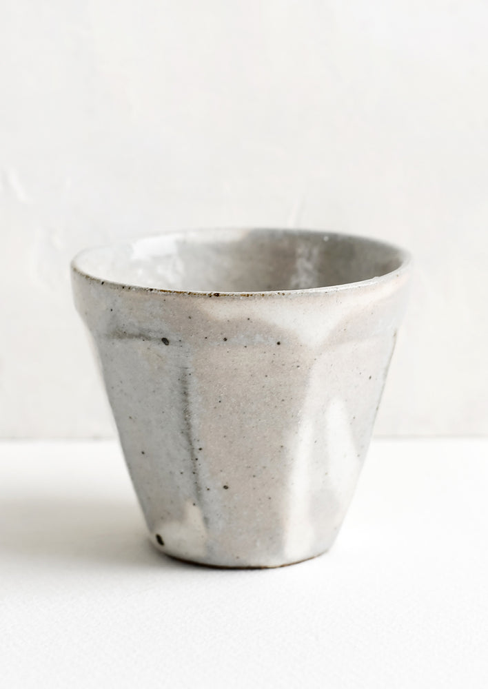 1: Small ceramic cups with faceted design.